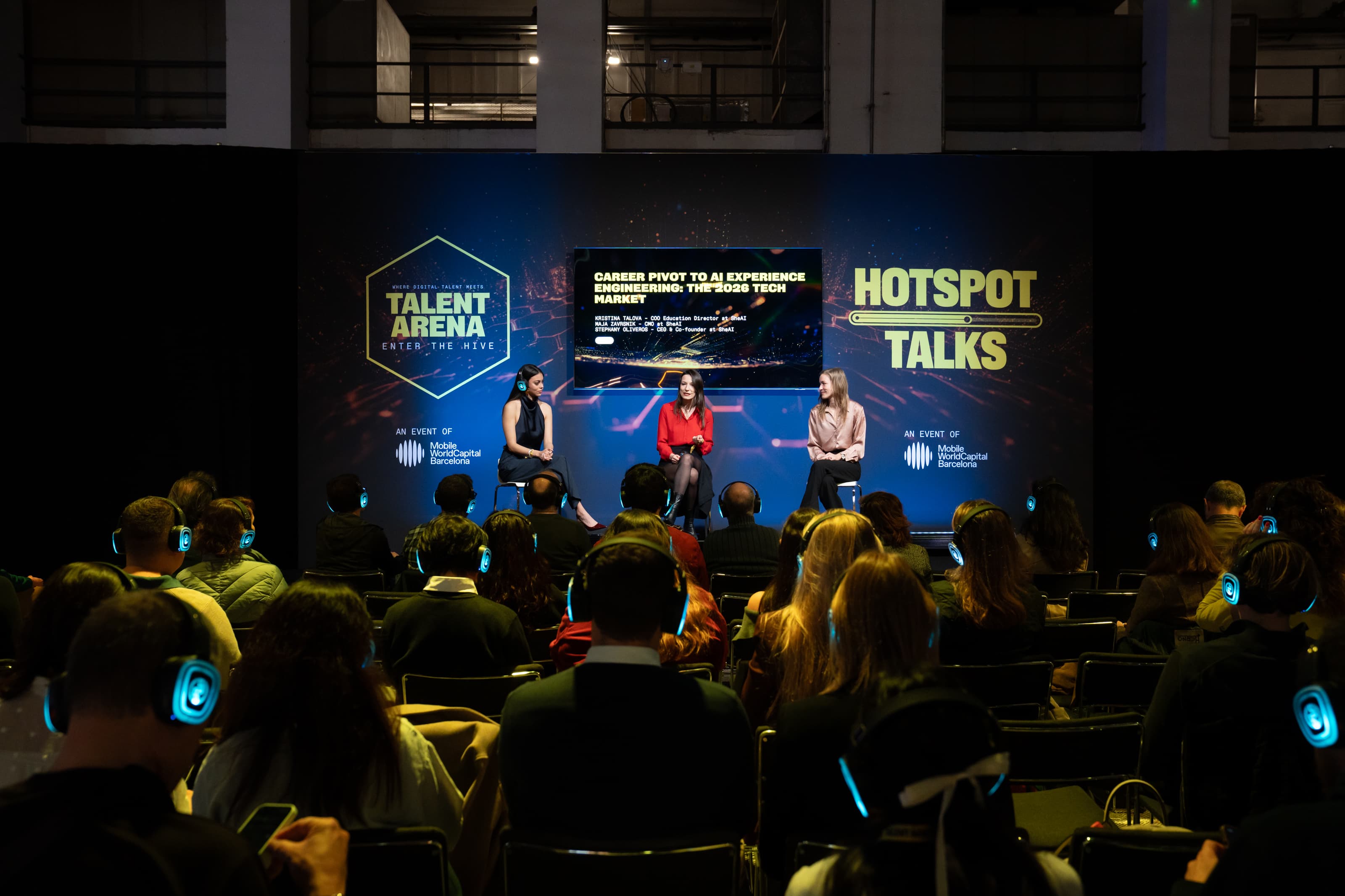 Stephany Oliveros speaking on the Talent Arena stage to a packed audience.